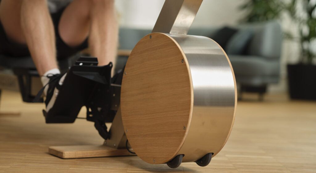 Close-up of the AUGLETICS rowing machine with elegant wood and metal design and integrated magnetic brake